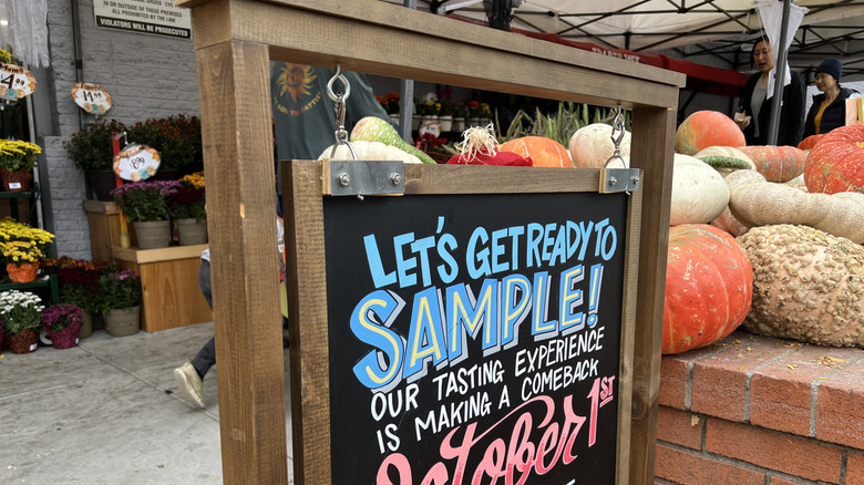 sign in front of trader joes store advertising samples