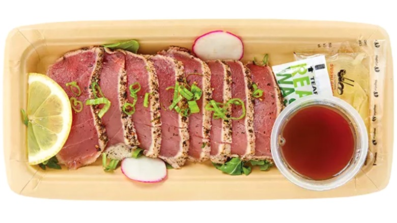 8 pieces of Tuna Tataki Sashimi with lemon garnish and soy sauce on the side