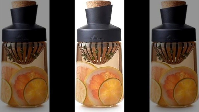 Rabbit liquor infuser with liquid, citrus slices, herbs inside