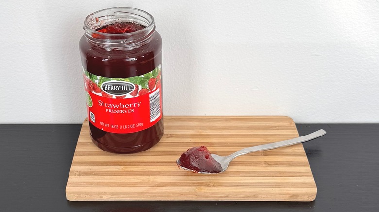 A jar of Berryhill Strawberry Preserves placed on a cutting board