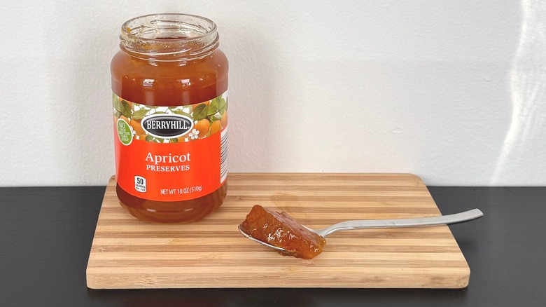 A jar of Berryhill Apricot Preserves placed on a cutting board