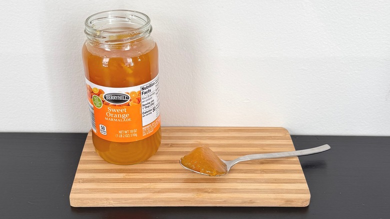 A jar of Berryhill Sweet Orange Marmalade placed on a cutting board