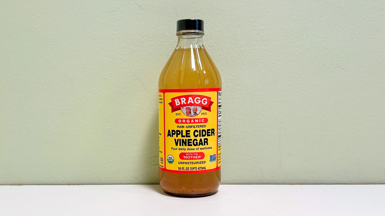 A bottle of Bragg Organic Raw and Unfiltered Apple Cider Vinegar