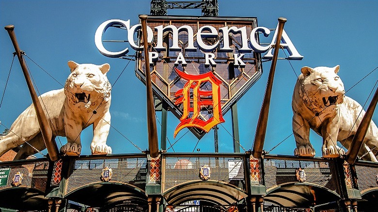 The sign for Comerica Park on the facade of the stadiums, with a tiger statue on either side