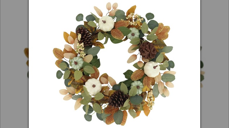 Fall-themed wreath with white pumpkins and eucalyptus leaves