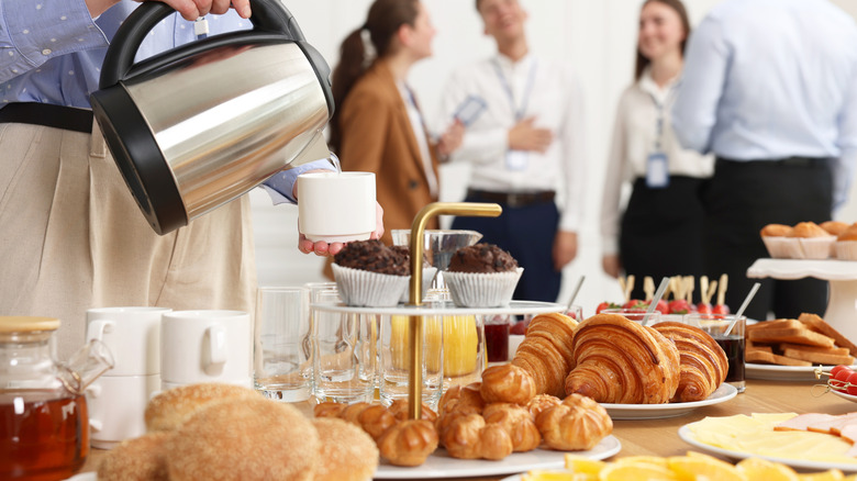 Person pouring coffee at buffet