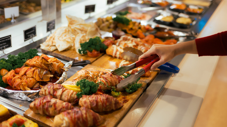 Woman serving self at buffet