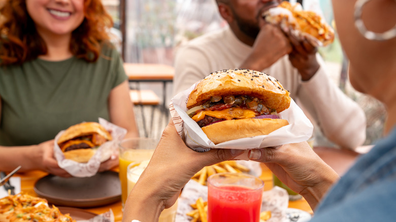 Group of friends eating fast food together