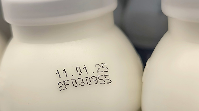 An expiration date is stamped on a milk bottle