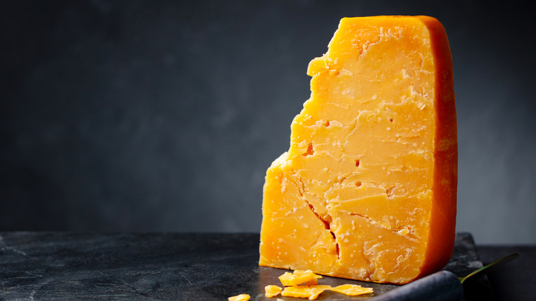 A block of aged Cheddar cheese