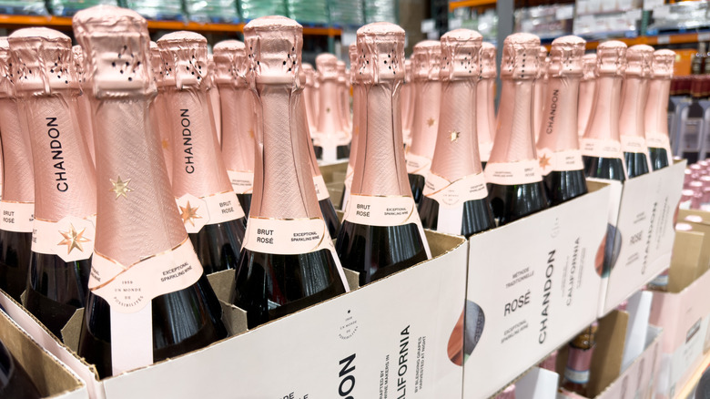 Multiple open cases of Chandon sparkling rose bottles displayed in store