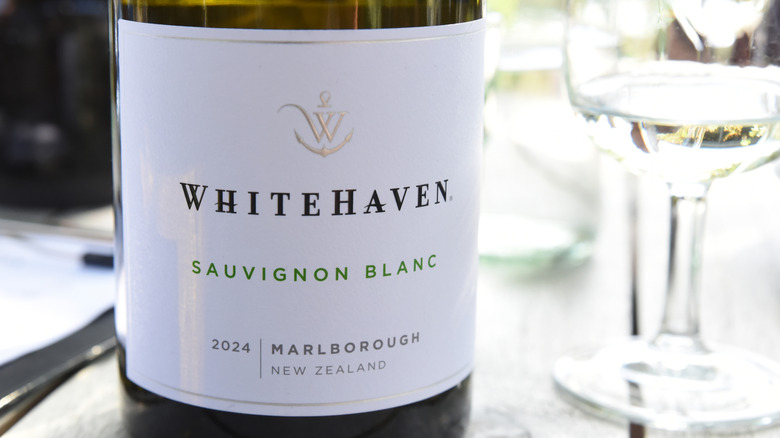 Close up of Whitehaven sauvignon blanc wine bottle label next to glass of wine