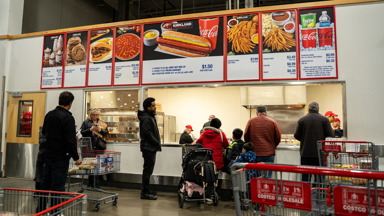 Customers wait in line at a Costco food court