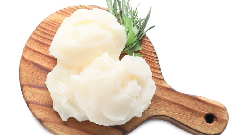 Beef tallow and herba on a wooden board