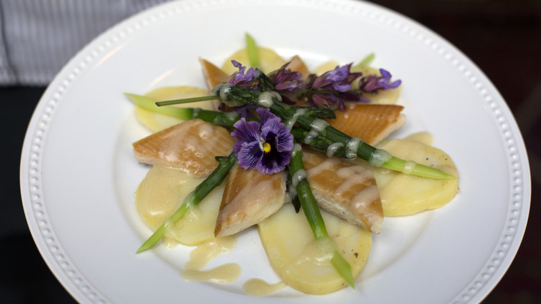 A smoked trout dish with asparagus and potatoes