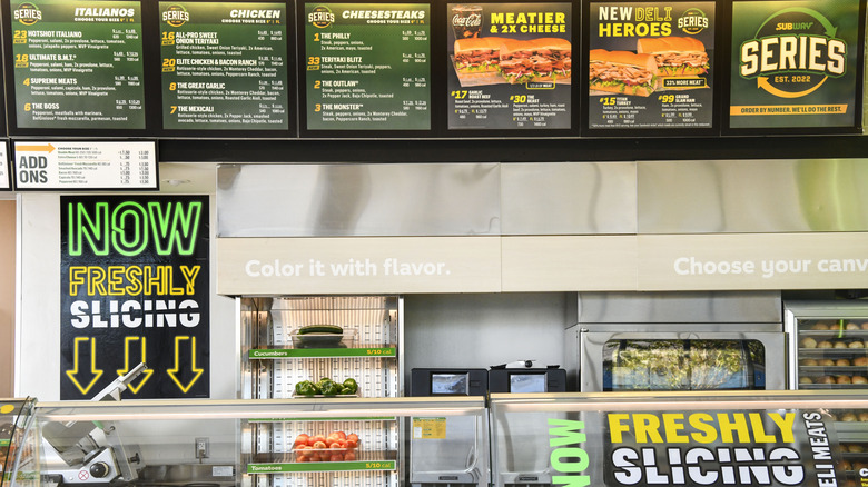 Subway menu visible behind counter