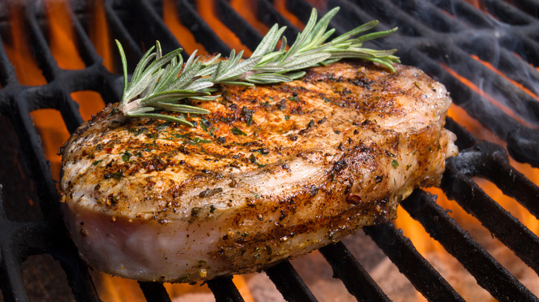 Grilled pork chop with fresh rosemary