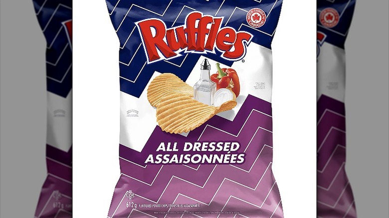 A packet of Ruffles All Dressed Chips with an illustration of 2 potato chips, a salt shaker, and a red pepper