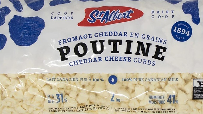 A blue and white packet of St-Albert Poutine Cheddar Cheese Curds