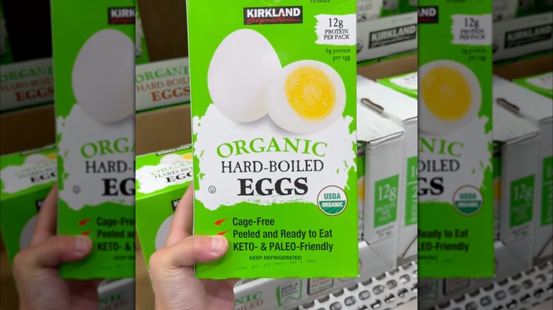Hand holding Kirkland organic hard-boiled eggs