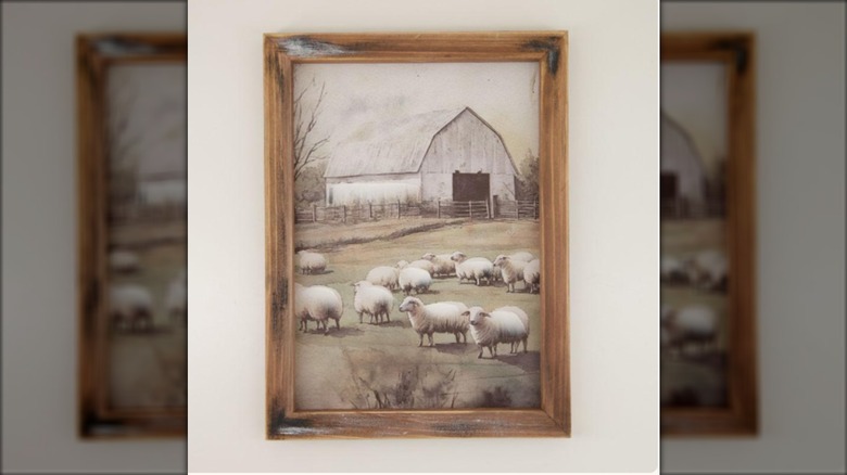 wooden frame with print of sheep on a farm with barn