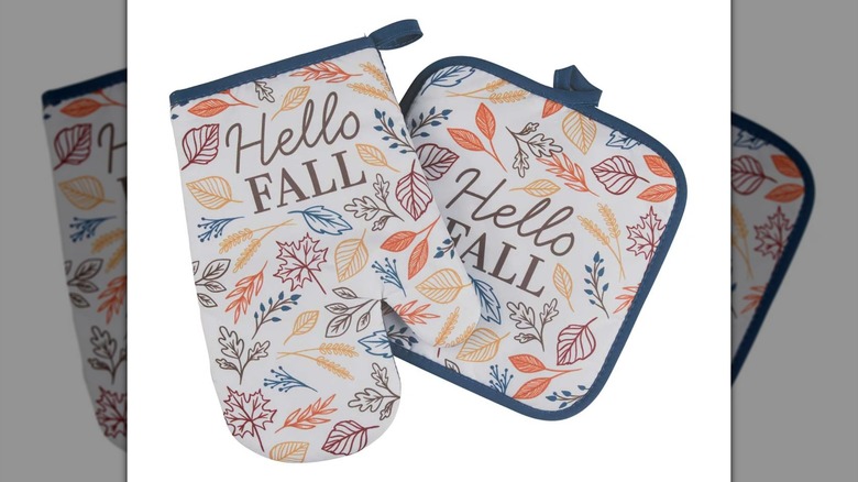 The Perfect Harvest Halloween Oven Mitt with "Hello Fall" printed on it on a white background