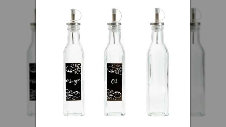 Three Glass Oil and Vinegar Bottles with Metal Pour Spouts on a white background