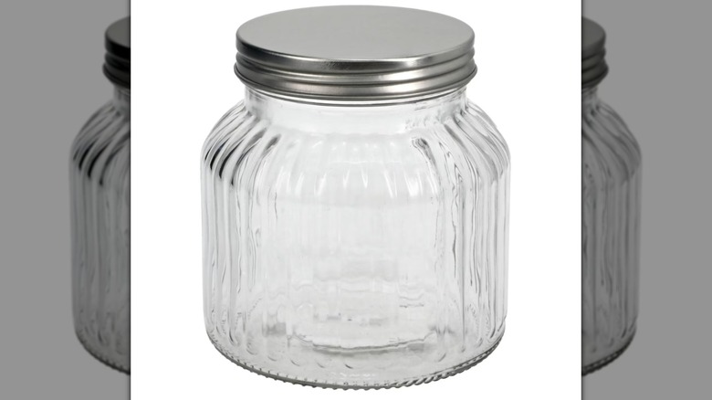 A Ribbed Glass Jar with a metal lid on a white background