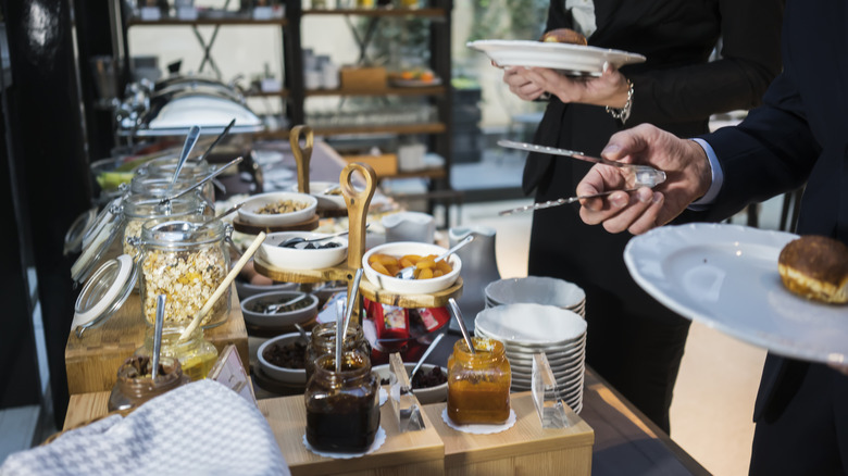Guests serving selves at breakfast buffet