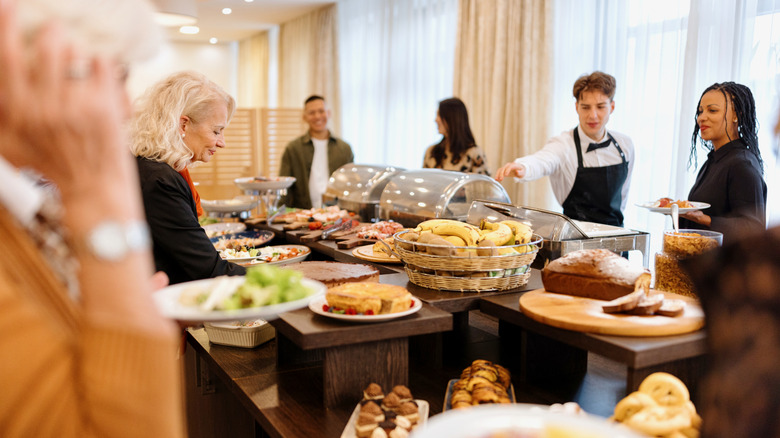 Guests serving selves at breakfast buffet