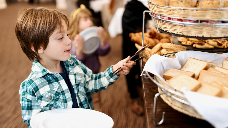 Child serving self at buffet