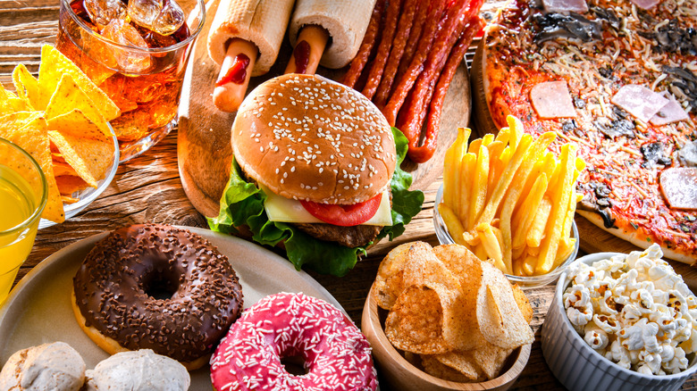 Various fast foods on a crowded table, shot from above