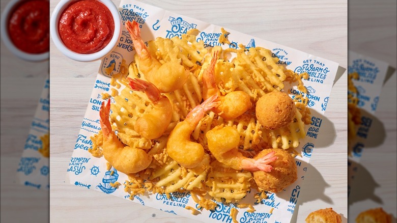 Long John Silver's Shrimp Basket with waffle fries, hushpuppies, and sauce.