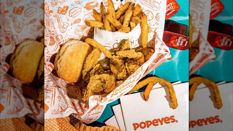 Popeyes Louisiana Kitchen Shrimp Tackle Box with biscuit, fries, and dipping sauce.
