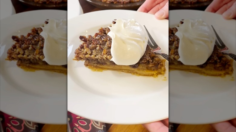Dolly Parton's butterscotch pie with whipped cream on a white plate with a fork.