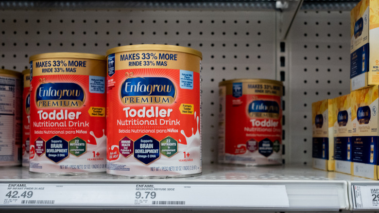 Cans of baby formula on shelf