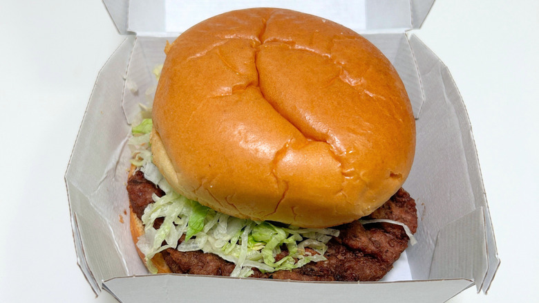 A close up of a Wawa All American Cheeseburger in its to-go container