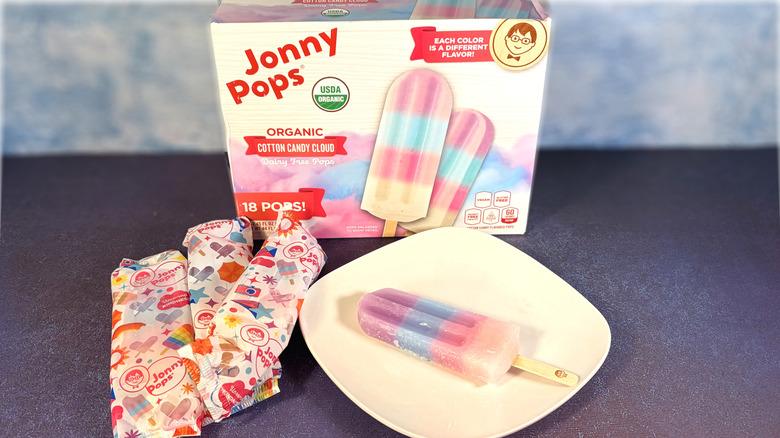 Multicolored popsicle on plate with package