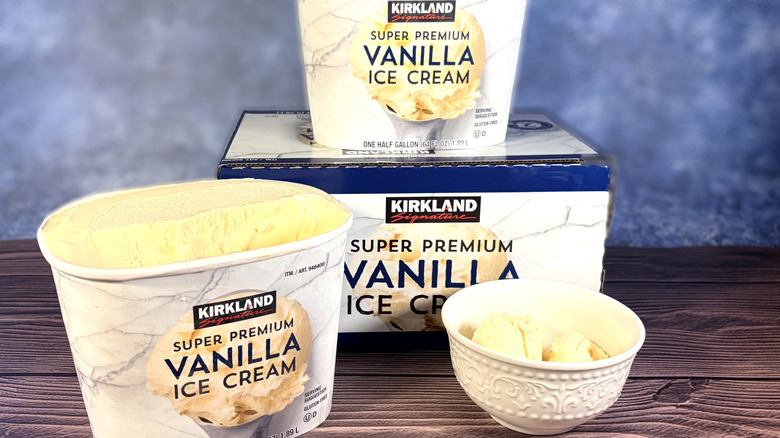 Tubs of vanilla ice cream with ice cream in bowl