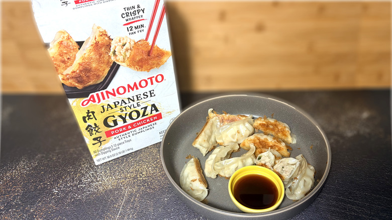 Plate of gyoza with bowl of dipping sauce and package