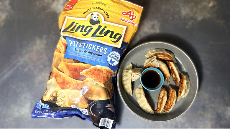 Plate of potstickers with bowl of dipping sauce and package