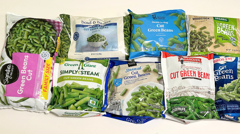 Eight frozen green bean brands arranged on a white surface