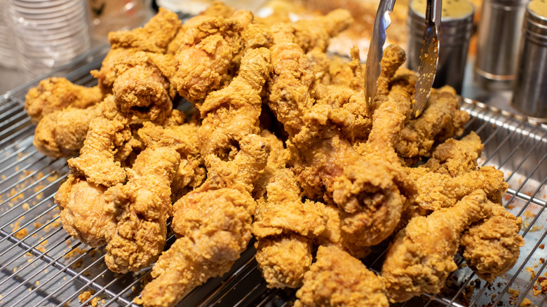 close-up of fried chicken cooling on wire rack