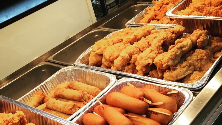 fried chicken, egg rolls, corn dogs in chafing dishes
