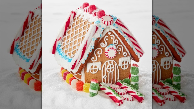 A gingerbread house with candy cane detailing, including a sidewalk of candy canes and peppermints