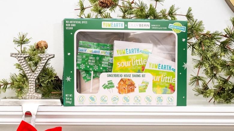 A box for the YumEarth Gingerbread House Baking Kit on a fireplace mantel