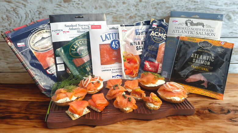 Eight brands of sliced smoked salmon bought at the grocery store with the salmon on bagels and crackers with cream cheese