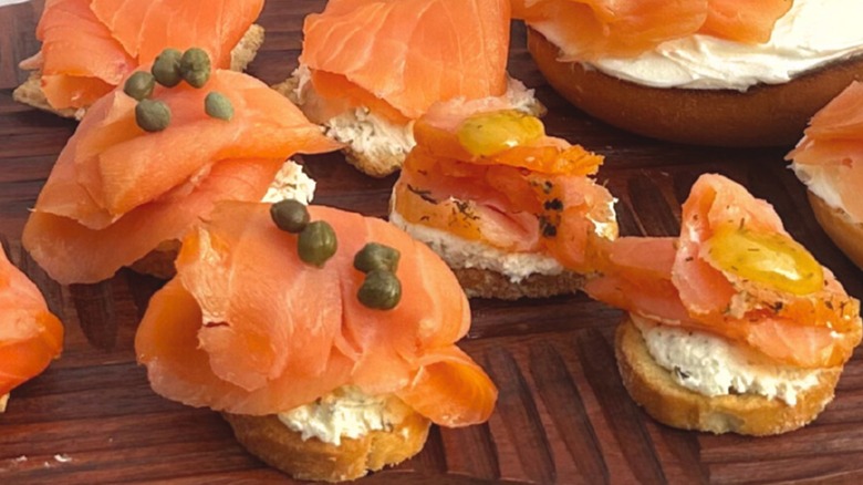 Fresh smoked salmon on crostinis with spread and toppings
