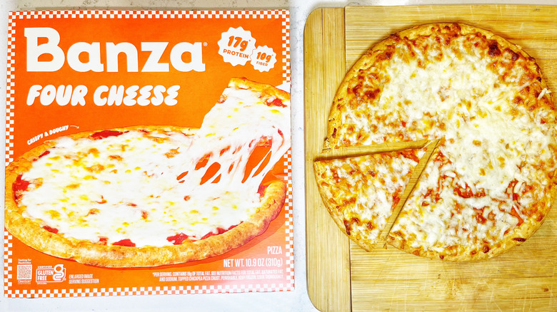 A Banza Four Cheese on a cutting board with one slice being pulled out