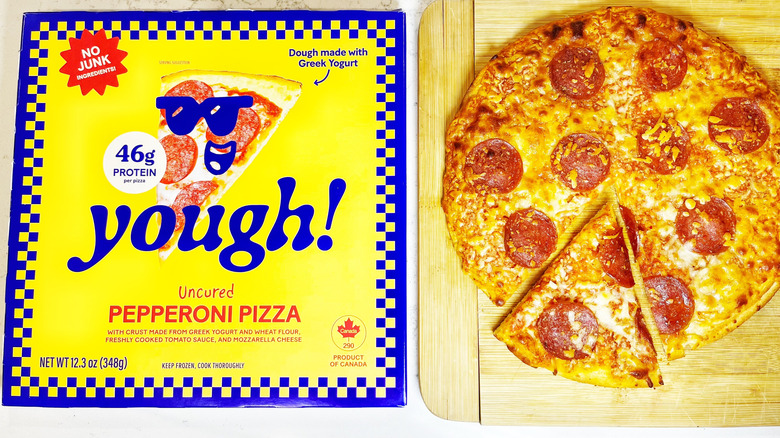 A Yough! Pepperoni pizza on a cutting board with one slice cut next to its box